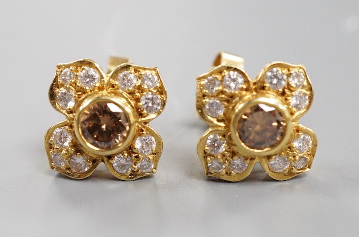 A modern pair of 750 yellow metal and two colour diamond cluster set earrings, 9mm, gross weight 4.1 grams, the central stone of a champagne/brown colour.